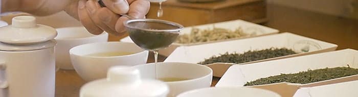 straining tea during a tea cupping session